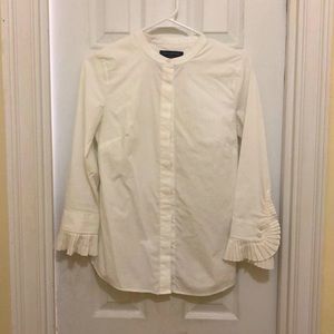 White blouse with ruffle sleeves.